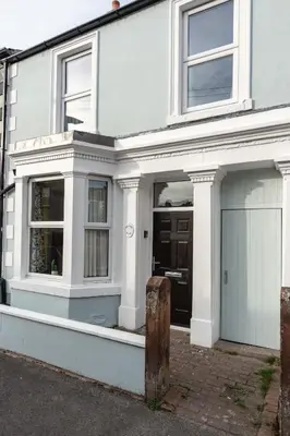 a white house with a garage at Daffodil House in Cockermouth