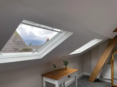 a skylight in a room with a table and a window at Grisedale Pike in Keswick