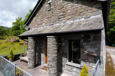 a stone building with a bench in front of it at Keiras Cottage in Ambleside