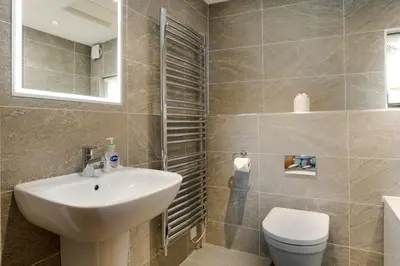 a bathroom with a sink and a toilet at Keiras Cottage in Ambleside