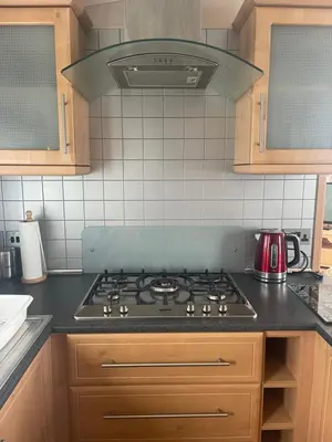 a kitchen with a stove top oven in a kitchen at Immaculate 2-Bed Lodge in Monreith in Newton Stewart