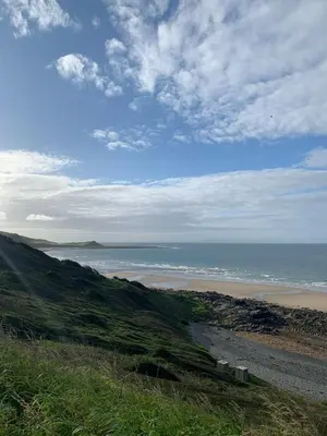 a view of the ocean and a sandy beach at Immaculate 2-Bed Lodge in Monreith in Newton Stewart