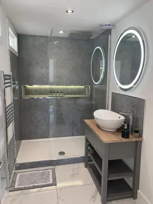 a bathroom with a shower with a sink and a sink at Luxury Cottage, views of the Lakes with Hot Tub in Cockermouth