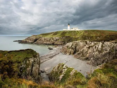 a lighthouse on top of a cliff near the ocean at Fawn's Velvet in Enoch