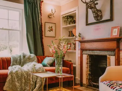 a living room with a couch and a fireplace at Fawn's Velvet in Enoch