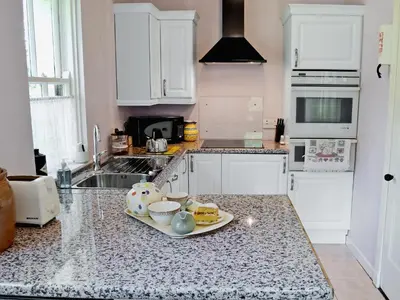 a kitchen with a plate of food on a counter at Gardener's Cottage in Palnure