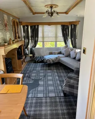 a living room with a couch and a table at 47 Lochview in Stranraer