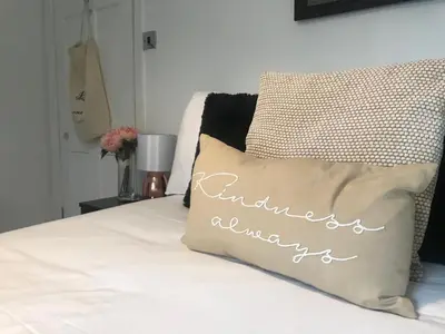 a bed with a pillow with the words anniversary at Mill Cottage modern cosy Lake District home with open fire near Scafell in Gosforth
