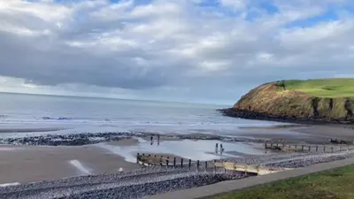a view of a beach with the ocean and a hill at Marni’s Cottage - Rural location & fell views in Frizington