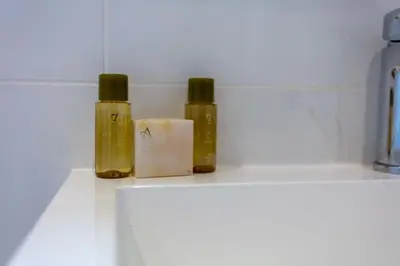 two bottles of essential oils sitting on top of a counter at West Sands - Donnini Apartments in Ayr