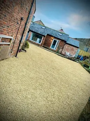 a large yard in front of a brick house at The Sty & The Stable in Carlisle