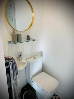a bathroom with a white toilet and a mirror at The Sty & The Stable in Carlisle