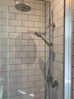 a shower with a glass door in a bathroom at The Sty & The Stable in Carlisle