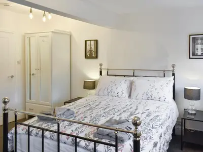 a bedroom with a bed and two lamps at Helvellyn House in Keswick