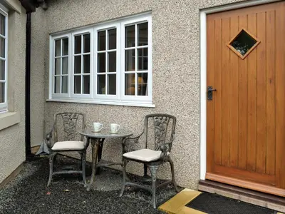 a table and chairs in front of a door at The Annex in Crosby