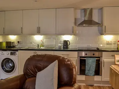 a kitchen with a leather chair in a kitchen at The Annex in Crosby