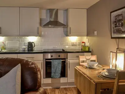 a kitchen with a table and a stove top oven at The Annex in Crosby