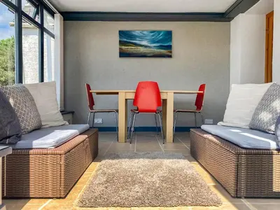 a dining room with a table and two chairs at Kerrim Cottage in Ringford