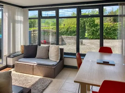 a living room with a couch and a table at Kerrim Cottage in Ringford