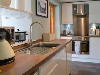a kitchen with a sink and a counter top at Kerrim Cottage in Ringford