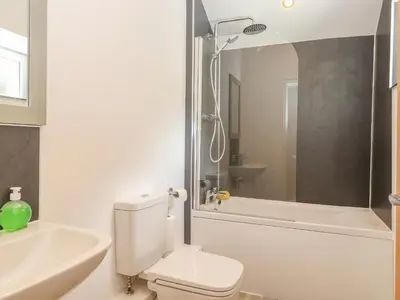 a bathroom with a toilet and a sink and a shower at Ladstock Cottage in Keswick