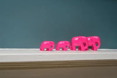 three pink elephant figurines sitting on a white shelf at Tig Cottage - a rural, quirky, pet friendly 2 bedroom cottage near Ballantrae in Ballantrae
