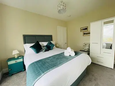 a bedroom with a large bed with two towels on it at Three Peaks in Braithwaite