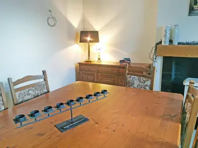 a wooden dining room table with a wooden tableablish at The Moorings in Lochmaben