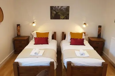 two twin beds in a room with two towels at Wastwater Cottage on The Big 