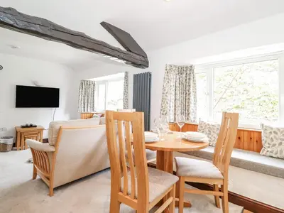 a dining room with a table and chairs at Woodloft Cottage in Elterwater
