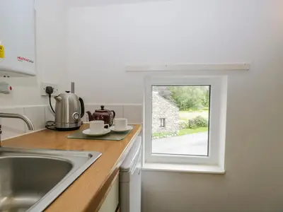 a kitchen with a sink and a window at Newfield Apartment 1 in Broughton in Furness