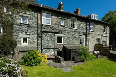 an old stone house with a garden in front of it at Oak Cottage Chapel Stile in Chapel Stile
