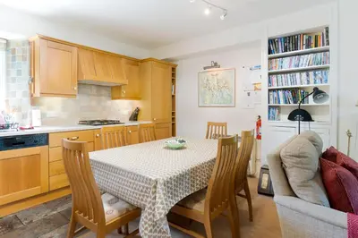 a kitchen with a table and chairs in a kitchen at Oak Cottage Chapel Stile in Chapel Stile