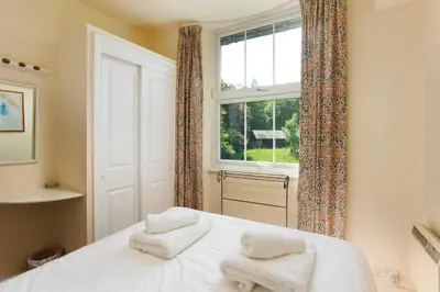 a bedroom with a bed with two towels on it at Oak Cottage Chapel Stile in Chapel Stile