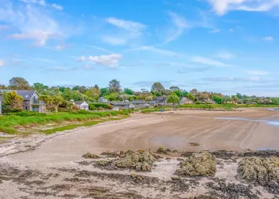 an empty road with houses in the background at Sandgreen Caravan Park in Girthon