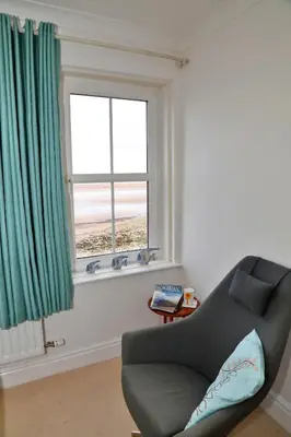 a living room with a chair and a window at Finest Retreats - Glendale in Skinburness