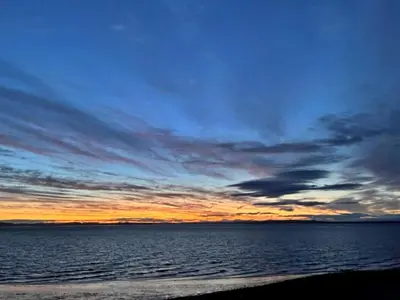 a sunset over a body of water at Finest Retreats - Glendale in Skinburness