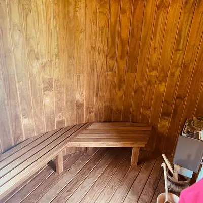 a wooden bench in a room with wood paneling at The Dairy in Castle Douglas