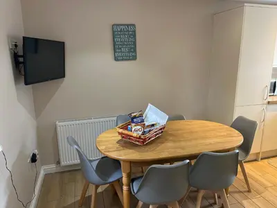 a dining room table with chairs and a basket of food on it at The Dairy in Castle Douglas