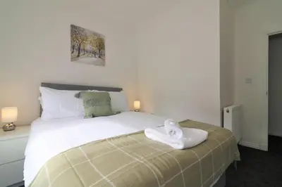 a bedroom with a bed with a towel on it at Signature - Kirkhill Middle in Kirkmuirhill
