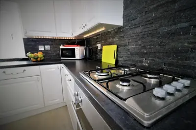 a kitchen with a stove top in a kitchen at Signature - Kirkhill Middle in Kirkmuirhill