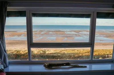 a window with a view of the beach at 14 Burnett House by Prestige Properties SA in Seascale