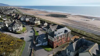 an aerial view of a town and the beach at 14 Burnett House by Prestige Properties SA in Seascale