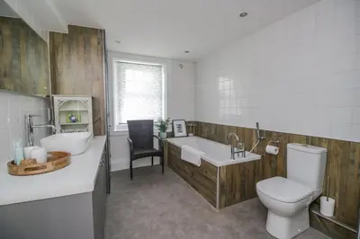 a bathroom with a toilet and a sink and a tub at 3 Clarks Terrace in Maryport