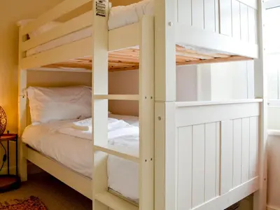 a bunk bed in a bedroom with a bunk bed in a room at The Old Vicarage in Westward