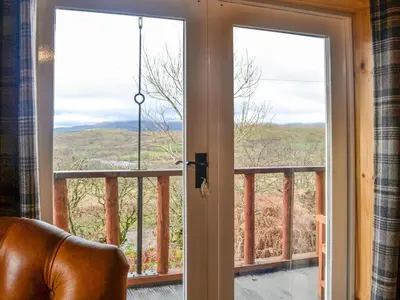 a view from the living room of the mountain view from the front door at Glenkens Lodge in Dalry