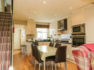 a kitchen with a table and chairs in a kitchen at Scale Force in Keswick