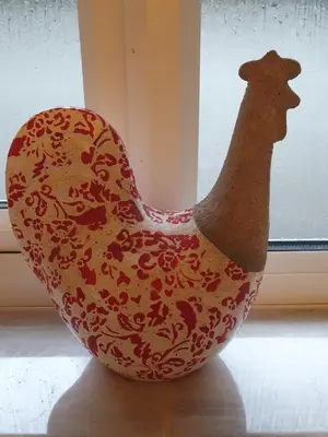 a chicken vase sitting in front of a window at Plum Cottage in Keswick