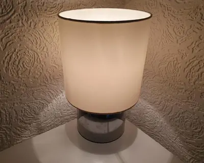a lamp sitting on a table in a room at Plum Cottage in Keswick