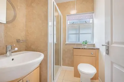 a bathroom with a sink and a toilet and a window at Cottage 9 Old Farmhouse Braithwaite in Keswick
